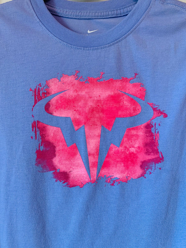 Blue t-shirt with a pink and blue logo 